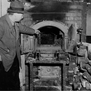 Deze Franse gevangene, die door het Amerikaanse 1ste Leger werd bevrijd uit concentratiekamp Flossenbürg in Duitsland, wijst naar een van de ovens van het kamp waarin de lichamen van slachtoffers van wreedheden werden gecremeerd. 800 Duitse SS-troepen hielden toezicht op dit kamp, dat in 1939 werd geopend. Volgens in het kamp gevonden documenten werden hier sindsdien 54.890 mannen en meer dan 10.000 vrouwen gevangen gehouden. In de periode van 14 maanden voorafgaand aan 20 april 1945 stierven 14.000 gevangenen door uitputting, ondervoeding, mishandeling en diverse ziekten. De gevangenen werkten in steengroeven en in een nabijgelegen Messerschmitt-vliegtuigfabriek. Op 20 april 1945 werden 15.000 gevangenen, onder wie kinderen en ouderen, weggevoerd. Degenen die de mars niet konden bijhouden, werden langs de weg vermoord. Ongeveer 2.000 mensen bleven achter toen de Amerikaanse troepen bij het kamp aankwamen. Onder degenen die naar verluidt in het kamp gevangen hebben gezeten, bevonden zich Kurt von Schuschnigg, voormalig kanselier van Oostenrijk, Leopold, koning der Belgen, prins Albrecht van Beieren en Hjalmar Schacht, rijksminister van Financiën.